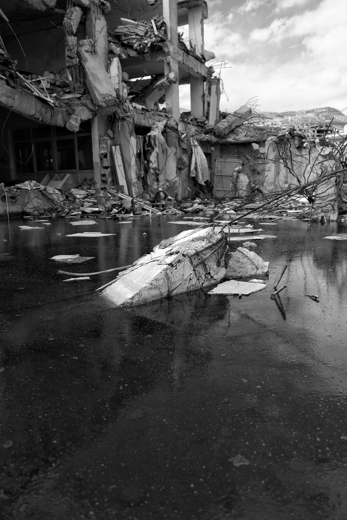 A damaged building surrounded by water, illustrating disaster recovery