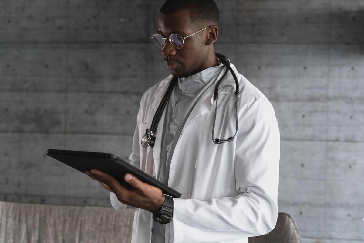 A healthcare professional using a tablet, illustrating digital learning in health services