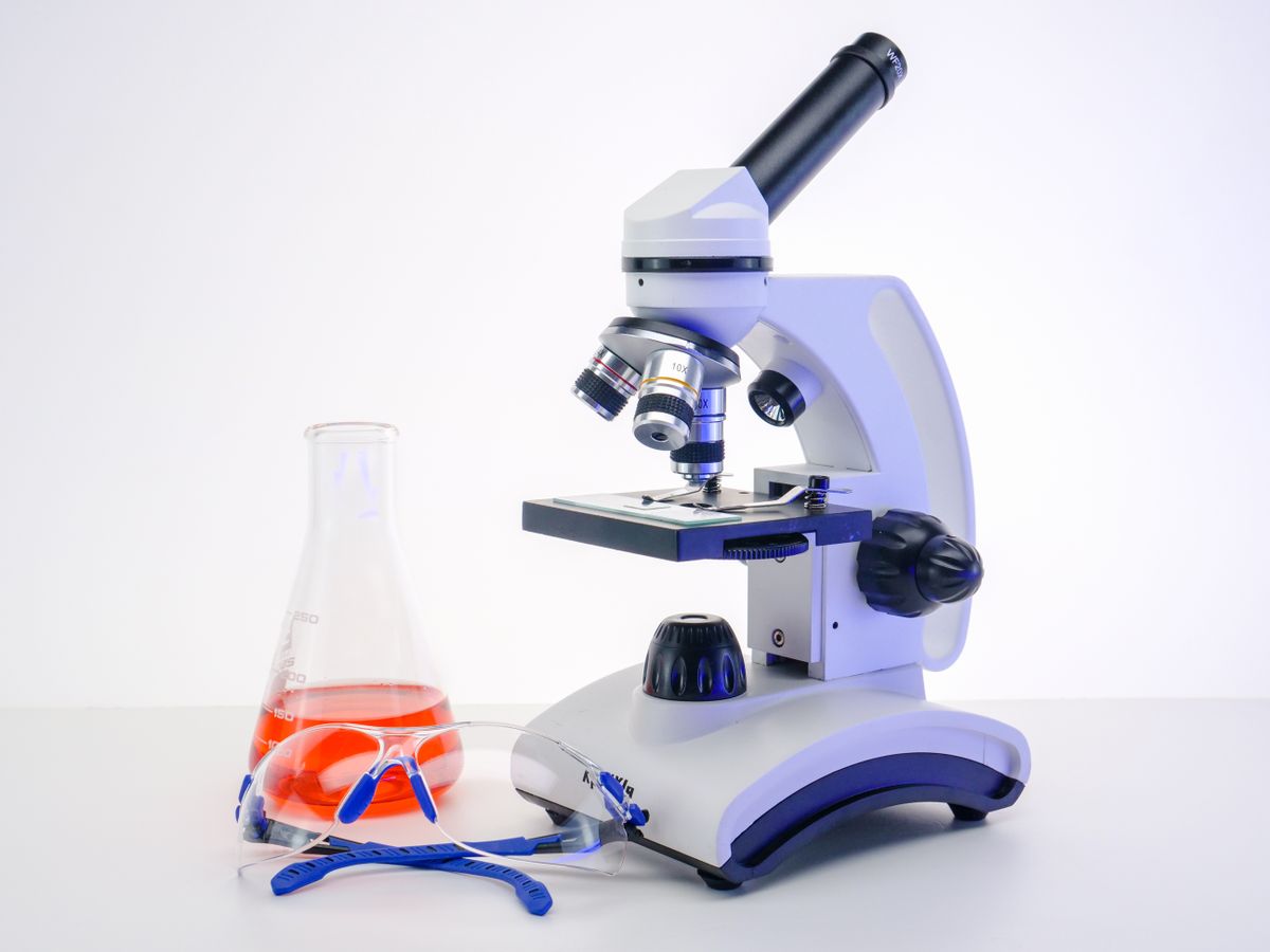 A microscope and laboratory glassware, illustrating infection research