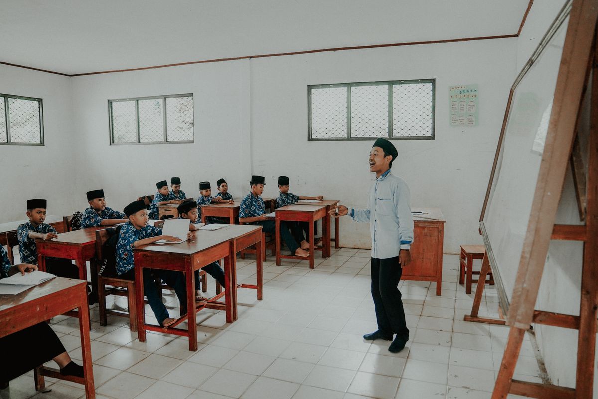 A teacher and students in an Indonesian classroom, illustrating learning and observation