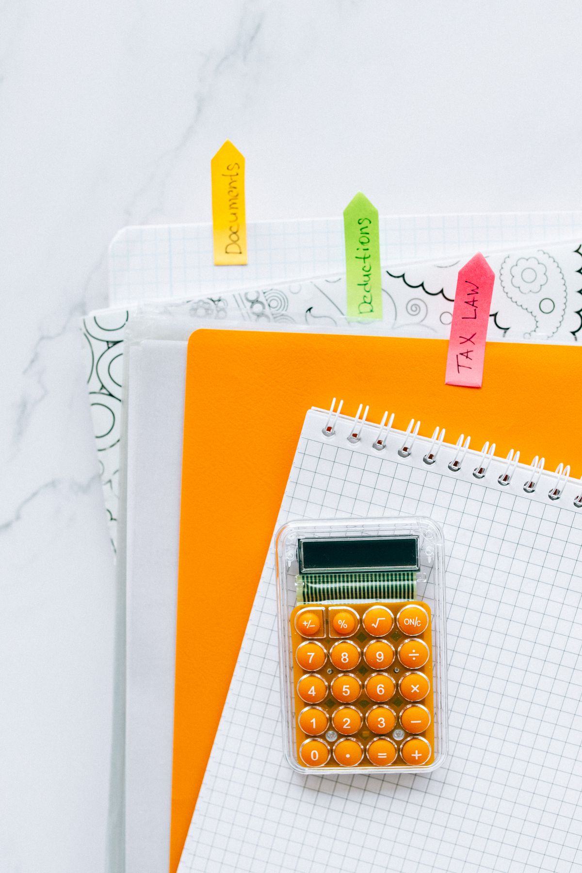 A calculator and organised documents, illustrating programme budgeting